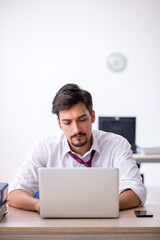 Young male employee working in the office