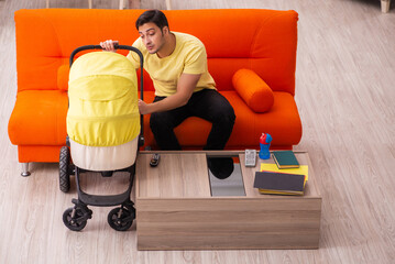 Young man looking after new born at home