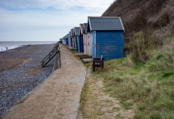 Row of wooden beach huts along Cromer promenade on the North Norfolk coast