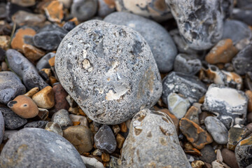 Fototapeta na wymiar Close and selective focus on a flint on Cromer beach on the North Norfolk Coast