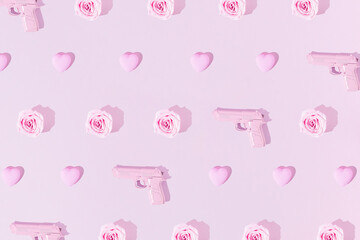 Romantic pattern made with pink guns, hearts and rose flowers. Creative love concept. Monochromatic purple background. Sunlight shadows.