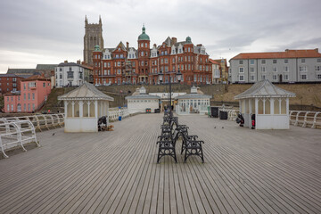 A view along the Victorian Cromer pier towards the seafront and town on a dull and overcast winter’s day