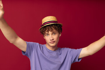 young guy fashion posing hand gestures stylish hat red background unaltered