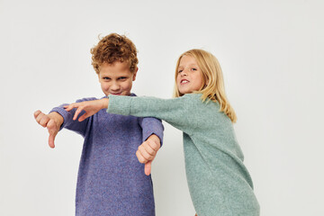 Portrait of cute children gesticulate with their hands together isolated background