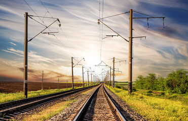 Fototapeta na wymiar Railway with two tracks on a background of sunset