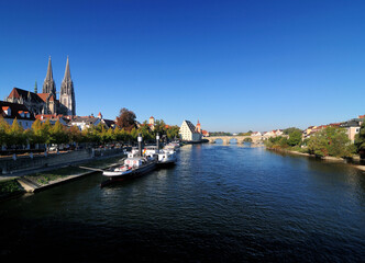 Fototapeta na wymiar View From The Donau River To The UNESCO Heritage Old City Of Regensburg Germany On A Beautiful Sunny Autumn Day With A Clear Blue Sky