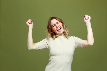 Happy overjoyed young woman celebrating fortune win victory success, rejoice triumph raised...
