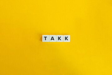 Takk Word on Letter Tiles on Yellow Orange Background. Minimal aesthetics.