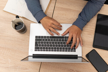 zenithal photo of young latin guy with his computer