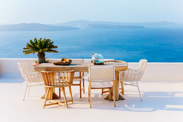 Table and seats at balcony in Oia in Santorini with great view