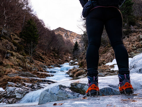 Trekking boots on an iced river
