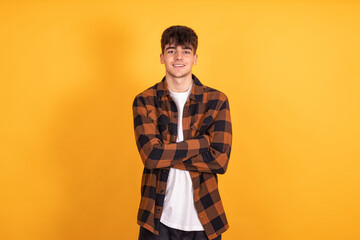 teenager boy isolated on yellow background © carballo