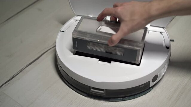 Automatic robot vacuum cleaner. Installing garbage container. Smart home.