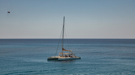 Fototapeta premium Catamaran in turquoise lagoon of the coast of Cyprus.