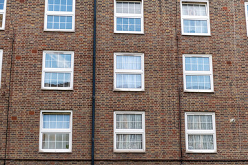 Fototapeta na wymiar A older style brick block of flats for council social housing in the East End of London. UK.