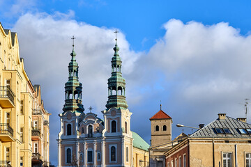 Historic tenement houses and bell towers of a baroque church