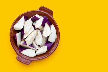 Fresh eggplant on yellow background. copy space