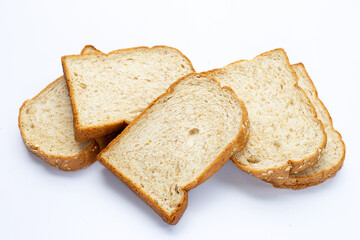 Stack of sliced wholegrain bread on white background.