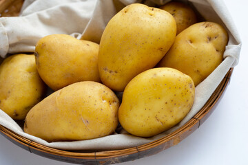 Raw potatoes in bamboo basket