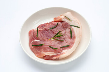 Pork meat in plate on white background.