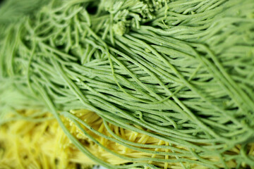 Raw green spaghetti noodles. The spaghetti is ready to cook. Top view.