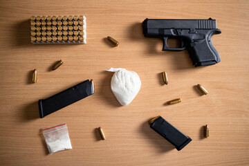 Drugs paraphernalia, gun, bullets and cocain narcotics packaging ready for street distribution. - obrazy, fototapety, plakaty