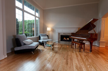 Remodeled large living room with glowing fireplace and new wooden floors