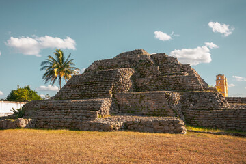 The pre-Columbian stepped pyramid at ancient Maya archaeological site in Acanceh, a small colonial town in Yucatán, Mexico. Anaceh has numerous Mayan Ruins.  Vintage tropical aspect concept.