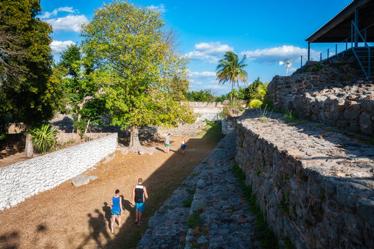 People visiting the pre-Columbian stepped pyramid at an ancient Maya archaeological site in Acanceh, a small colonial town in the Yucatán Peninsula, Mexico. 
