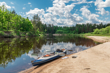 Fototapeta na wymiar Outdoor activities forest river reflection of sky and kayak