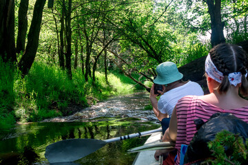 On kayak on river rowing two girls difficult area photograph