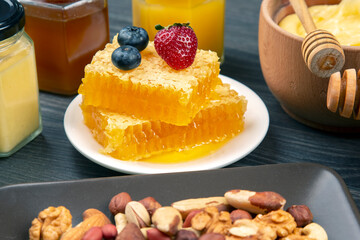 Fresh flower honey of different varieties, pollen and honeycomb with spoons on a wooden background. Organic Vitamin Health Food