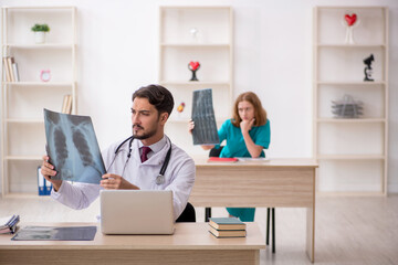 Young male doctor radiologist and female assistant working in th