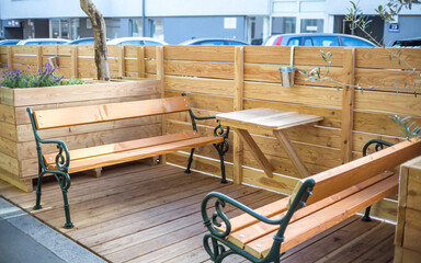 Sitting area on street at coffee shop no people