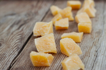parmesan cheese cubes on a wooden table with close up