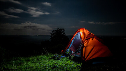 A small tent on the hill at night