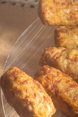 Rice patties or fritters made of cooked rice, carrot, onion, garlic, celery stalks,Brazilian rice cakes,copy space and natural anbiente.