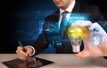 Businessman holding a light bulb, online security concept