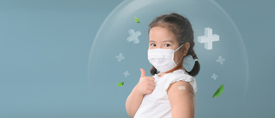 Coronavirus Vaccination Advertisement. Happy Vaccinated Little asian child girl Showing Arm With...