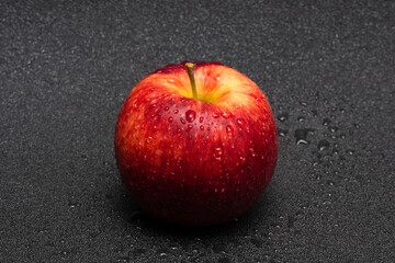 Red apple with water droplets