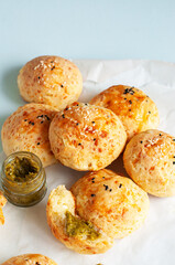 Homemade cheesy dinner rolls with sesame seeds.