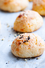 Homemade cheesy dinner rolls with sesame seeds.