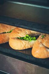 Sandwiches in the making. Fresh buns with filling on the plancha grill.