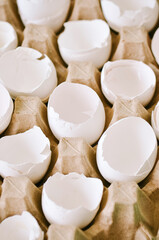 Cracked egg shells in a carton container. Close up.