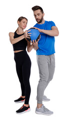 Athletic couple doing exercise with medicine ball on white background