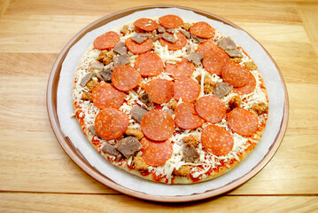 Perfect Raw Meat Lovers Pizza Ready for the Oven	
