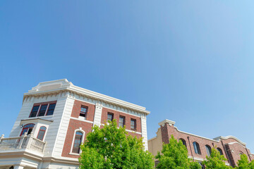 Two buildings with red bricks and white wall claddings at San Marcos, California