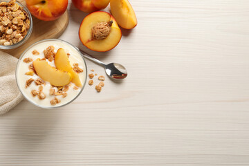 Flat lay composition with tasty peach yogurt on white wooden table. Space for text