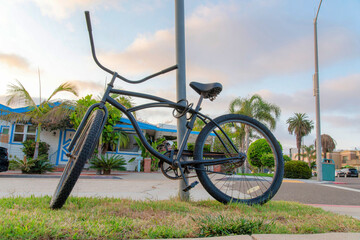Fototapeta na wymiar Tied bicycle on a metal posts near the road at La Jolla, California