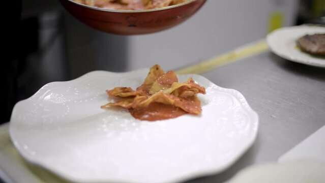 Chef sou-chef cook preparing a traditional mexican dish called chilaquiles at a local cafe diner restaurant in latin america